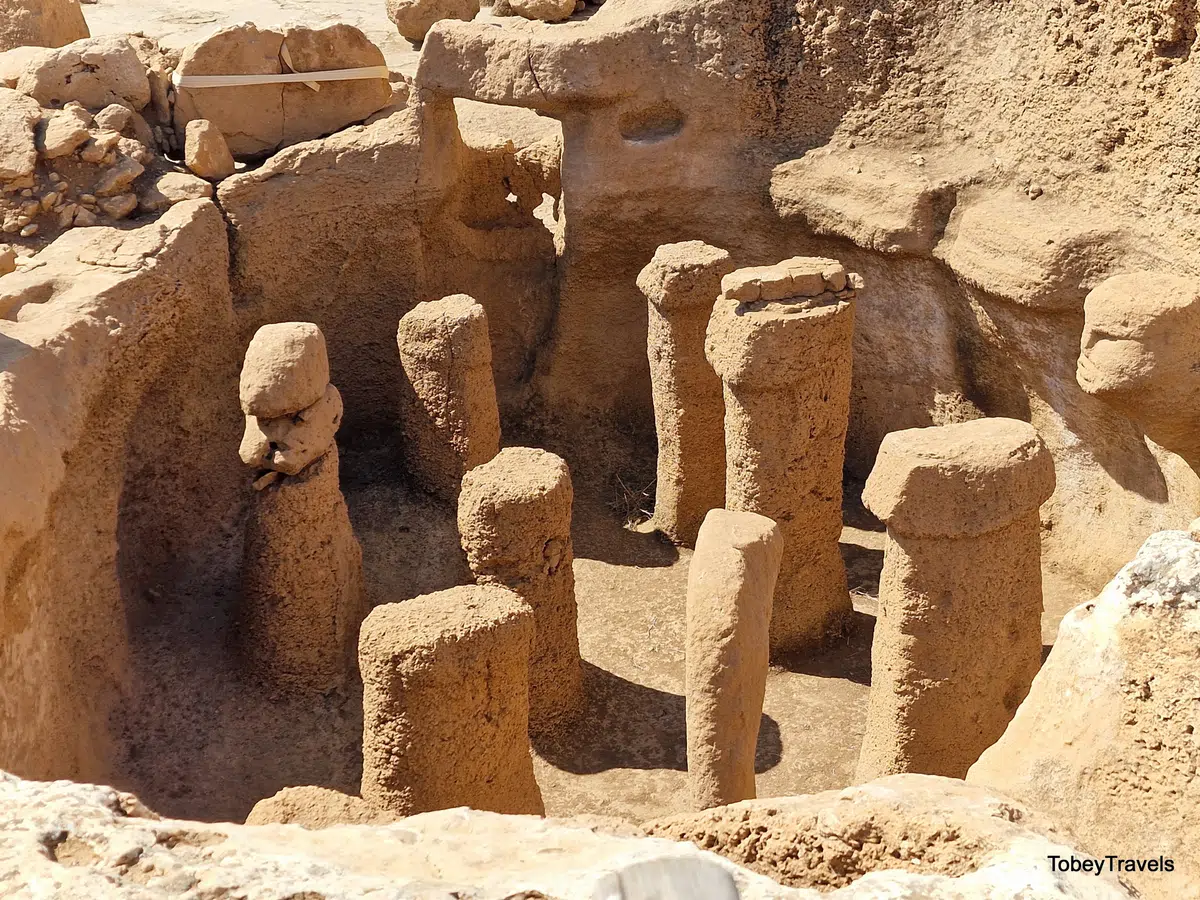 Bedrock pillars and a carved head in Structure AB at Karahan Tepe.